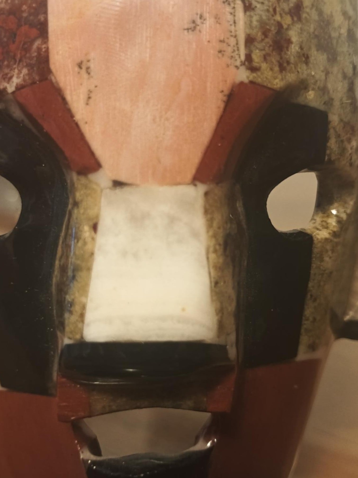 Polo Express Teotihuacan-style mask, handcrafted with red jasper, obsidian, and mother of pearl inlay.